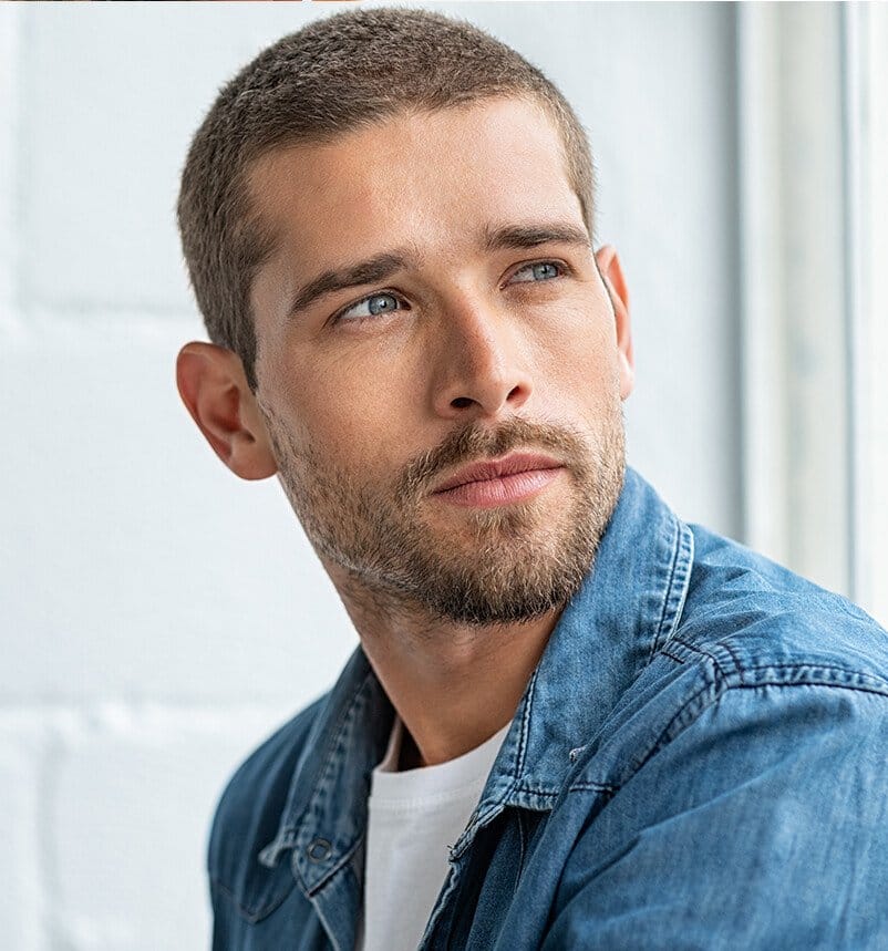 man with a beard and a white shirt looking off to the side