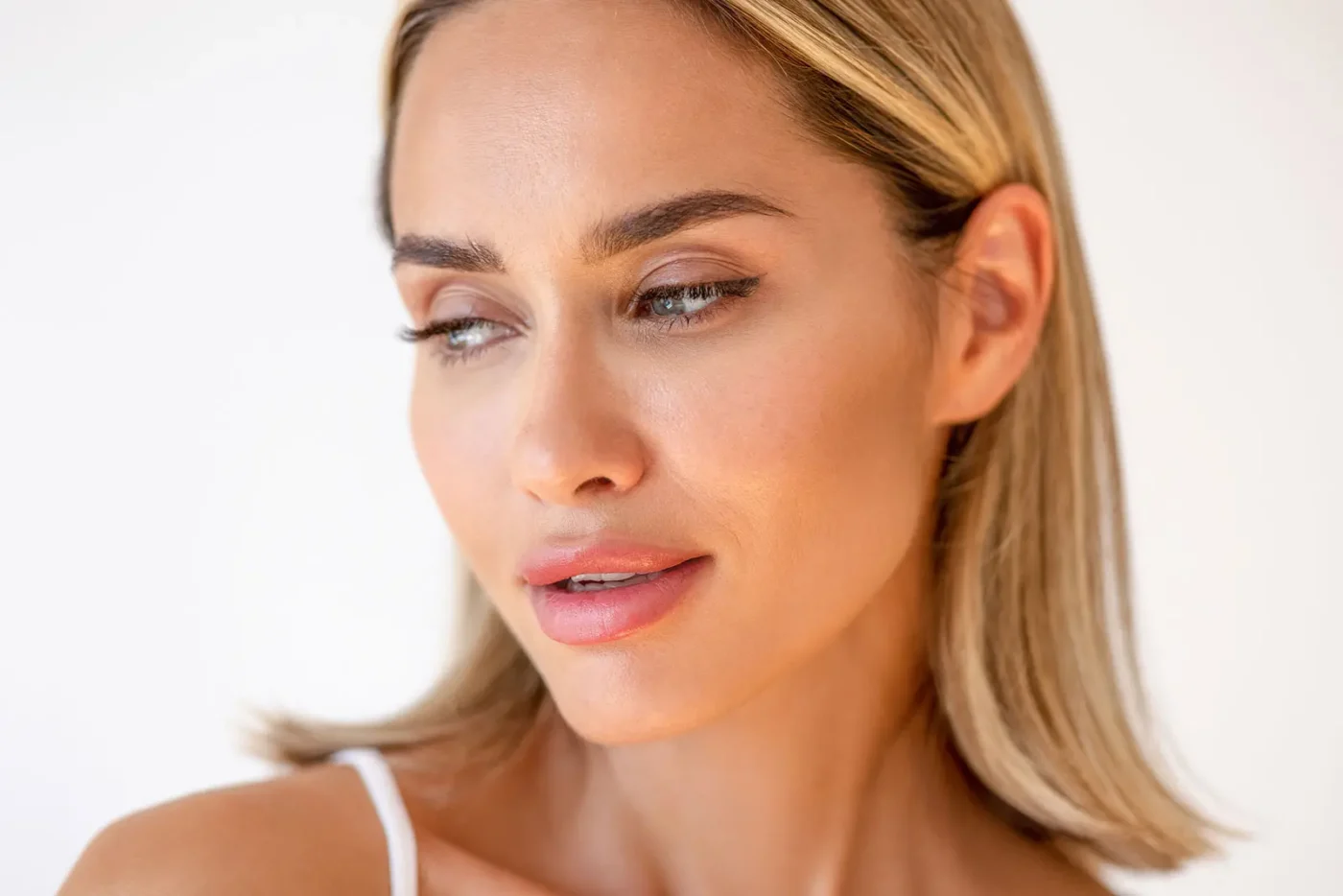 Woman with seductive face looking down and away from camera