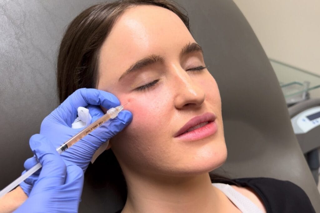Dr. Chiang carefully performing a PRF treatment on a patient. The doctor is using a precise technique in a sterile, modern clinical setting, highlighting the professional and focused nature of the regenerative procedure.