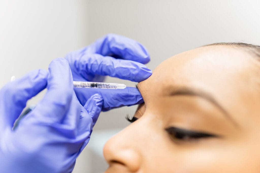 Dr. Melissa Chiang performing Botox treatment on female patient in The Woodlands, TX 