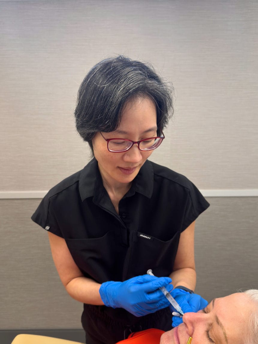 Dr. Melissa Chiang performing Sculptra treatment in clinic in The Woodlands, TX.